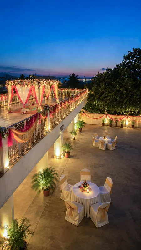 Rooftop celebration space at dusk, strung with warm lights