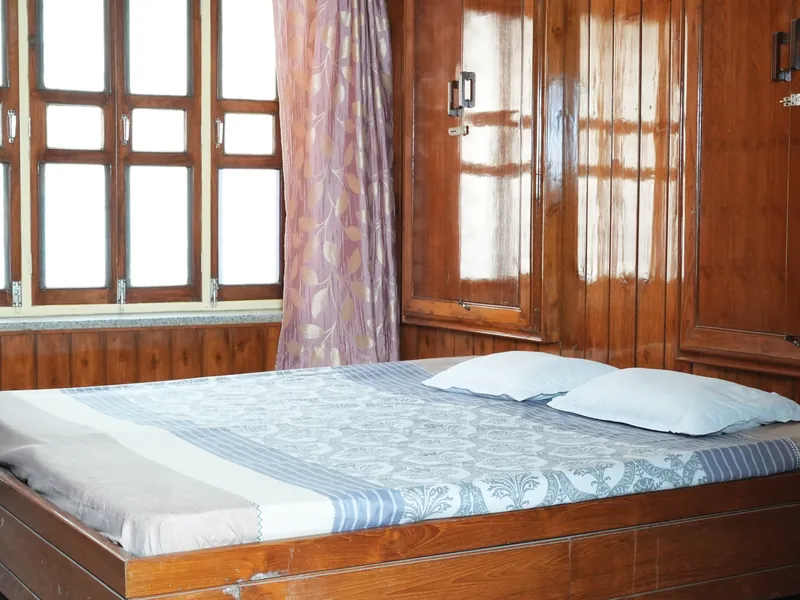 Guest room with double bed and printed linen