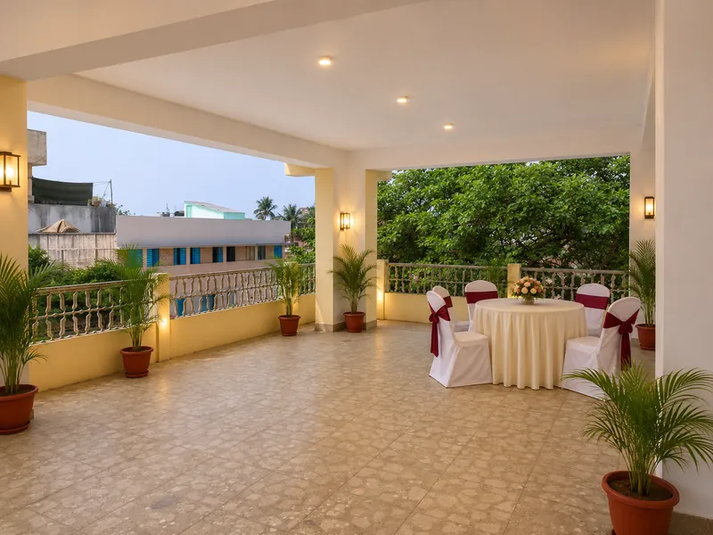 The covered terrace with seating, surrounded by greenery